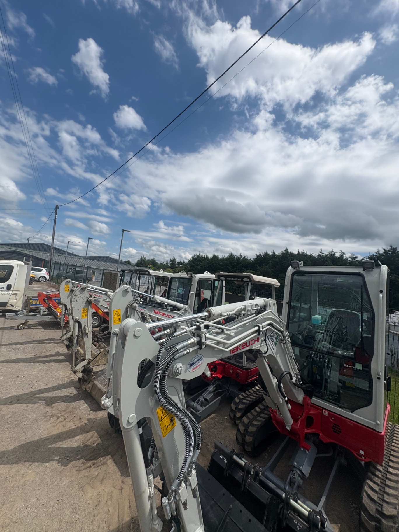 Takeuchi mini diggers lined up in our yard